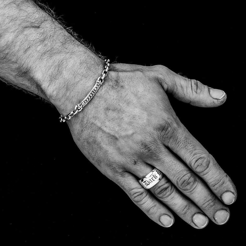 Large Solid Silver band inscribed with words in an old letter font on a male model hand