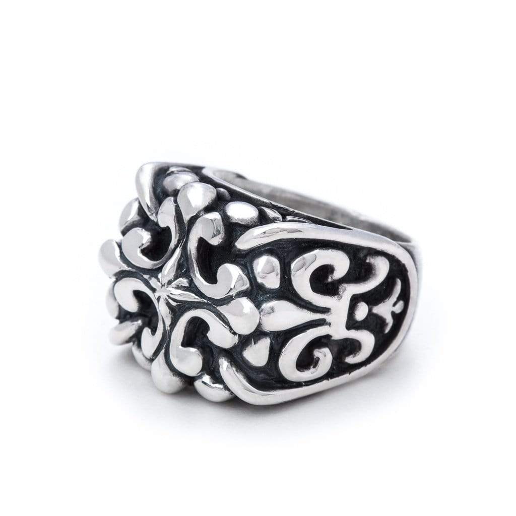 Large solid sterling silver ring, intricate cross design and similar shaped designs along the side of the ring visible at this angle
